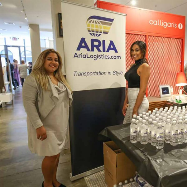 Aria Logistics booth at New York Fashion Week with Transportation in Style banner